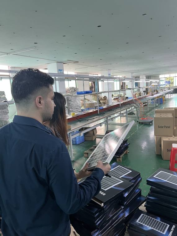 Founder inspecting product quality on a factory production line