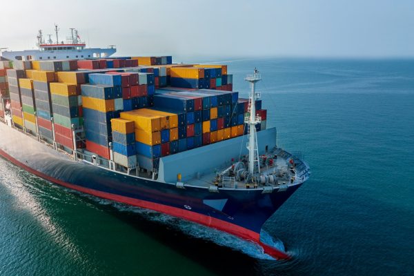 Aerial side view of cargo ship carrying container and running for export goods from cargo Aerial side view of cargo ship carrying container and running for export goods from cargo